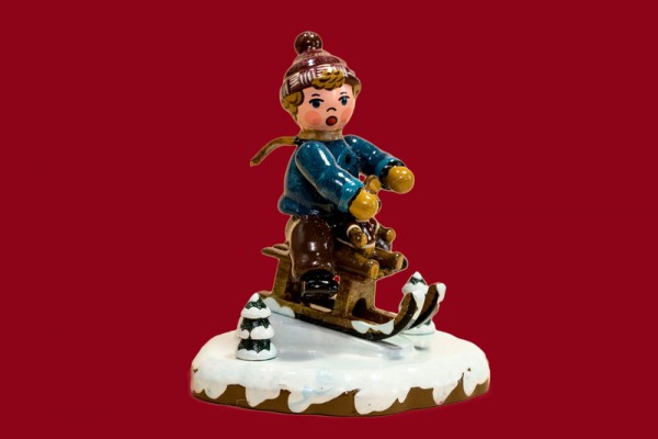 Winterkind Schlittenfahrer